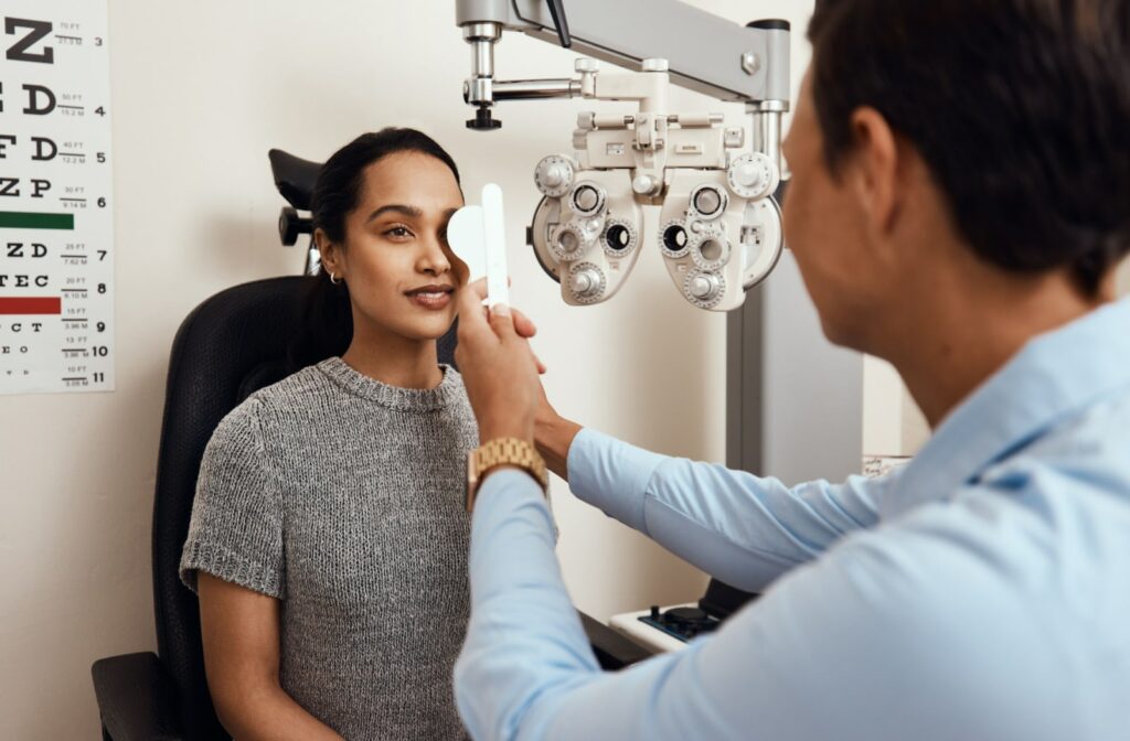 An optometrist examines a female patient's eyes