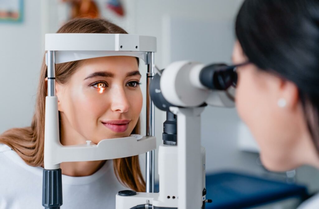 A smiling female patient during an eye exam.