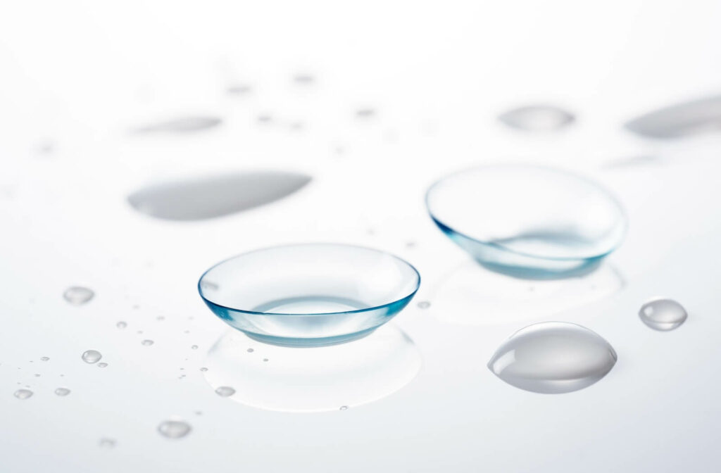 Contact lenses on a white back ground with water droplets.