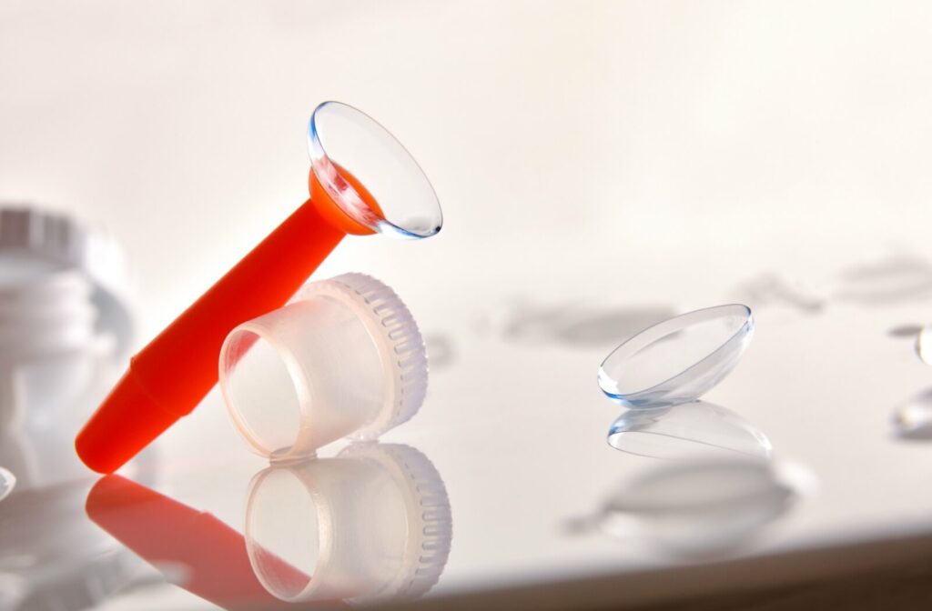 An orange suction tool cupping a scleral contact lens.