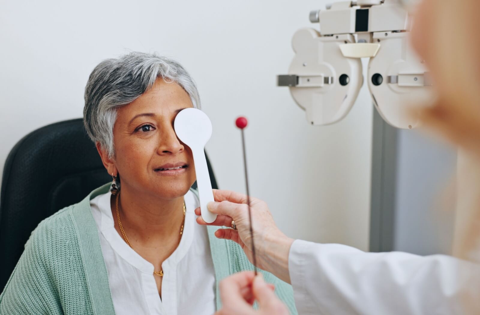 Person undergoing a vision test during a comprehensive eye exam at an optometry clinic.